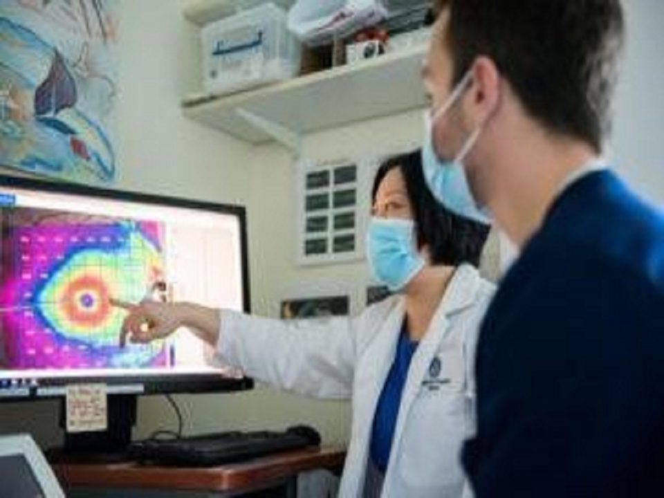 Doctors pointing at a computer image