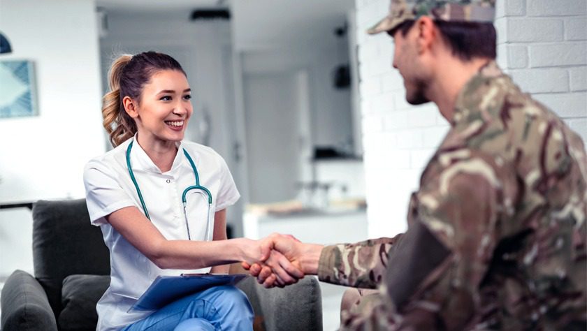health professional greeting soldier