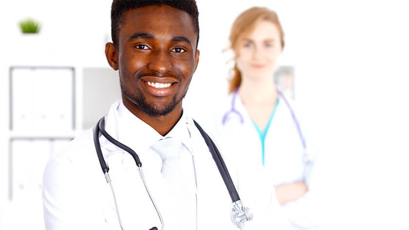 Male doctor with female doctor in background