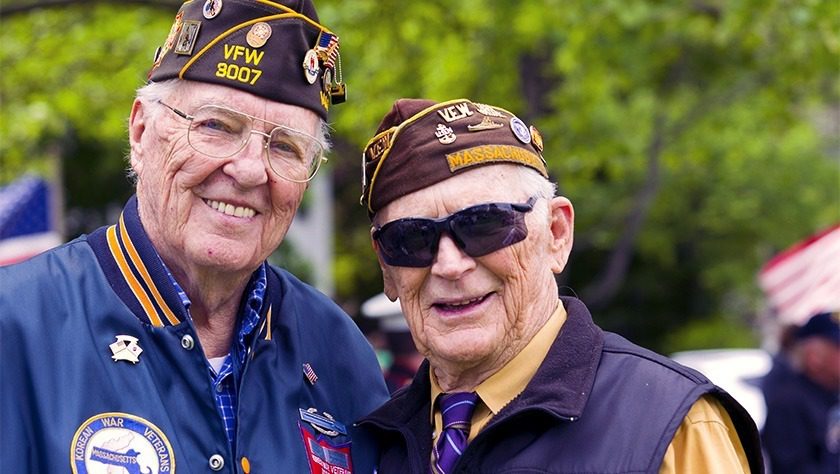 Two decorated veterans pose side by side